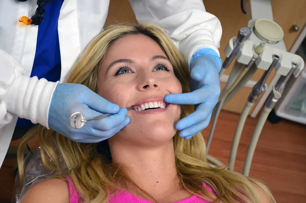 Dentist gently examining a patient in the dental chair